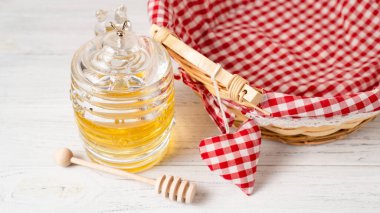 Masada güzel bir bal kavanozu var. Orijinal bal küpü. Mutfak masasındaki bal için aksesuarlar. Bal takımı