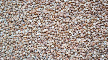 Kuru karabuğday arka planı, karabuğday yakın plan. Kızarmış karabuğday. Kahverengi mısır gevreği. Sağlıklı karabuğday dokusu