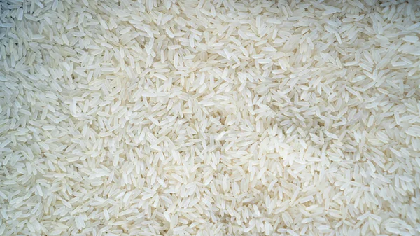 Arroz basmati como fondo. Fondo de textura de detalle de arroz jazmín, primer plano del fondo de arroz —  Fotos de Stock