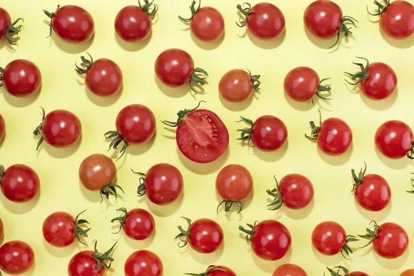Cherry tomatoes on a yellow background. Food. Red tomatoes. Cherry tomatoes