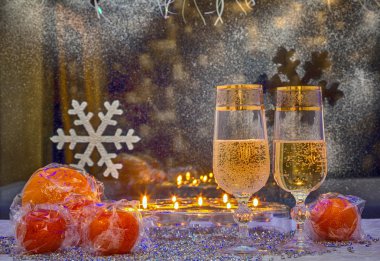 glasses of champagne and mandarin against the window. Photo in o