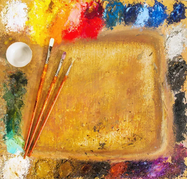 Paints, brushes, palette, canvas and painted. — Stock Photo © natapro