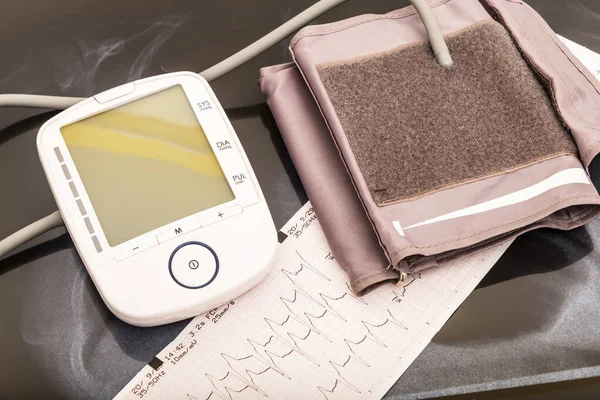 still life of a stethoscope with pacemaker battery and heart pressure measuring device together with medical objects.