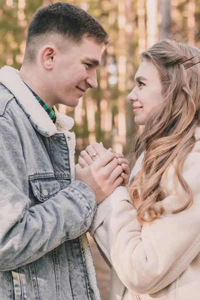 Guy Holds Girl Hands Looks Her Smiles While Pine Forest — стоковое фото