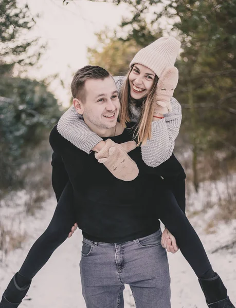 Woman Sits Man Back Smiles Background Snowy Forest — Stock Photo, Image