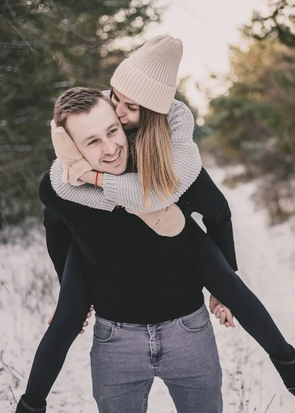 Woman Sits Man Back Smiles Background Snowy Forest — Stock Photo, Image