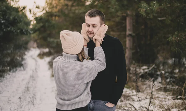 Woman Dressed Mittens Hugs Man Face Background Snowy Forest — Stock Photo, Image