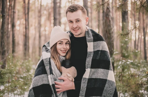 Man Hugs Woman Covered Blanket Background Winter Pine Forest — Stock Photo, Image