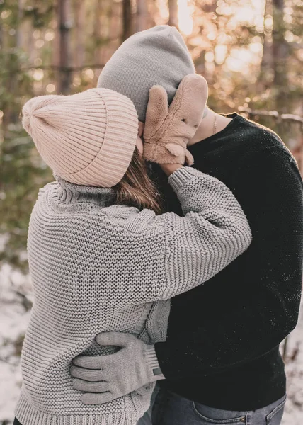 Woman Kisses Hugs Man Dressed Mittens Pine Forest — Stock Photo, Image