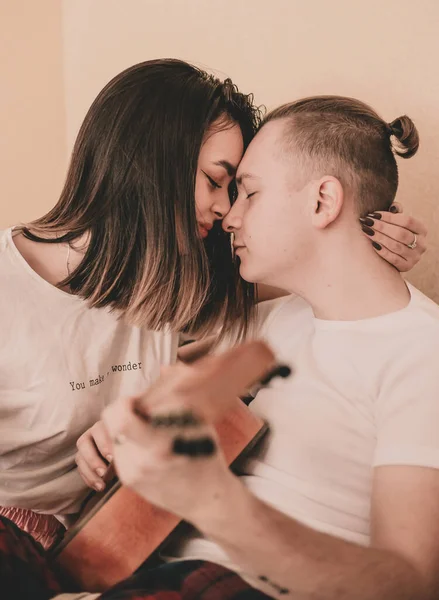 Couple Pajamas Home Woman Hugs Man Plays Guitar — Stock Photo, Image