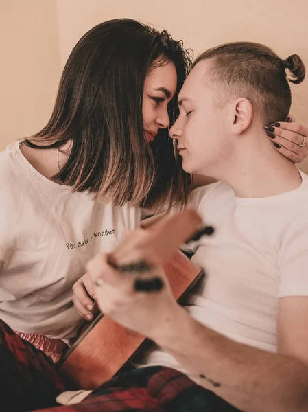 Couple Pajamas Home Woman Hugs Man Plays Guitar — Stock Photo, Image