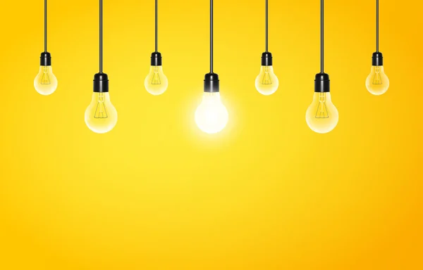 Hanging light bulbs with glowing one on a yellow background, copy space. Vector illustration for your design. — Stock Vector