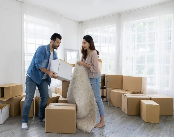 Husband and wife starting a new life just bought a house and moved in. Together they lifted many parcels, moved into the house and arranged.