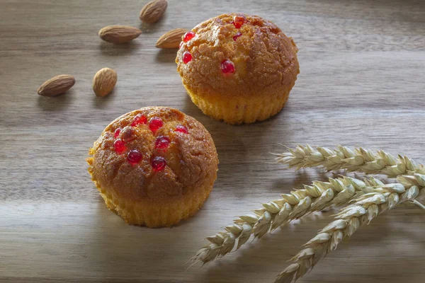 Gluten free almond flour cupcake, muffins with raspberries. Copy space, light wooden background