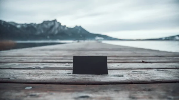blank business card on the background of the Austrian mountain lake