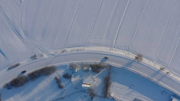 winter road top view. long turn on a slippery snowy road. dangerous road icy