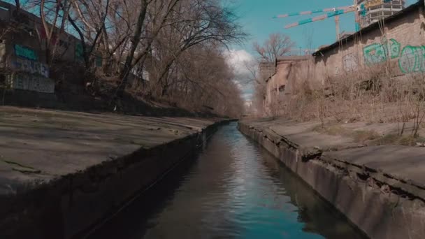 El río, que fluye en un embalse de hormigón en la ciudad. — Vídeo de stock