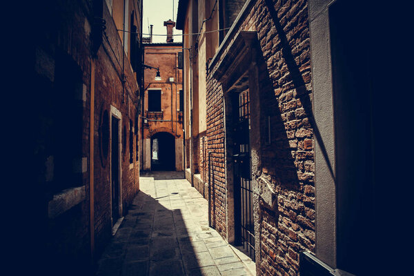 Beautiful day in Venice. The Venetian Street on sunny day with historic houses. play of light and shadow on ancient streets