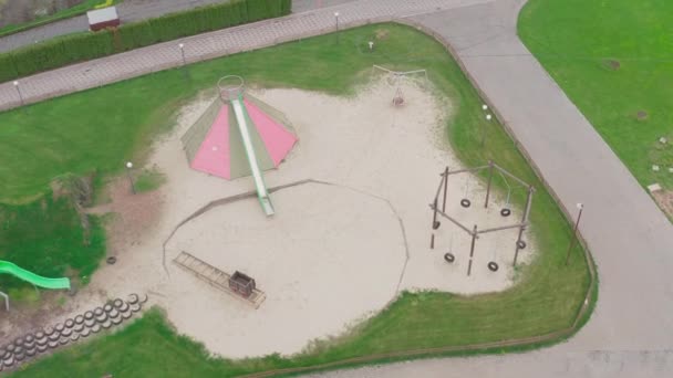 Closed empty childrens colourful outside playground. pine cone slides. — Stock Video