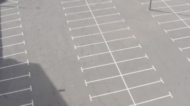 En üstteki boş otopark. Kuru asfalt güneşli bir gün. beyaz çizgi işaretleri 
