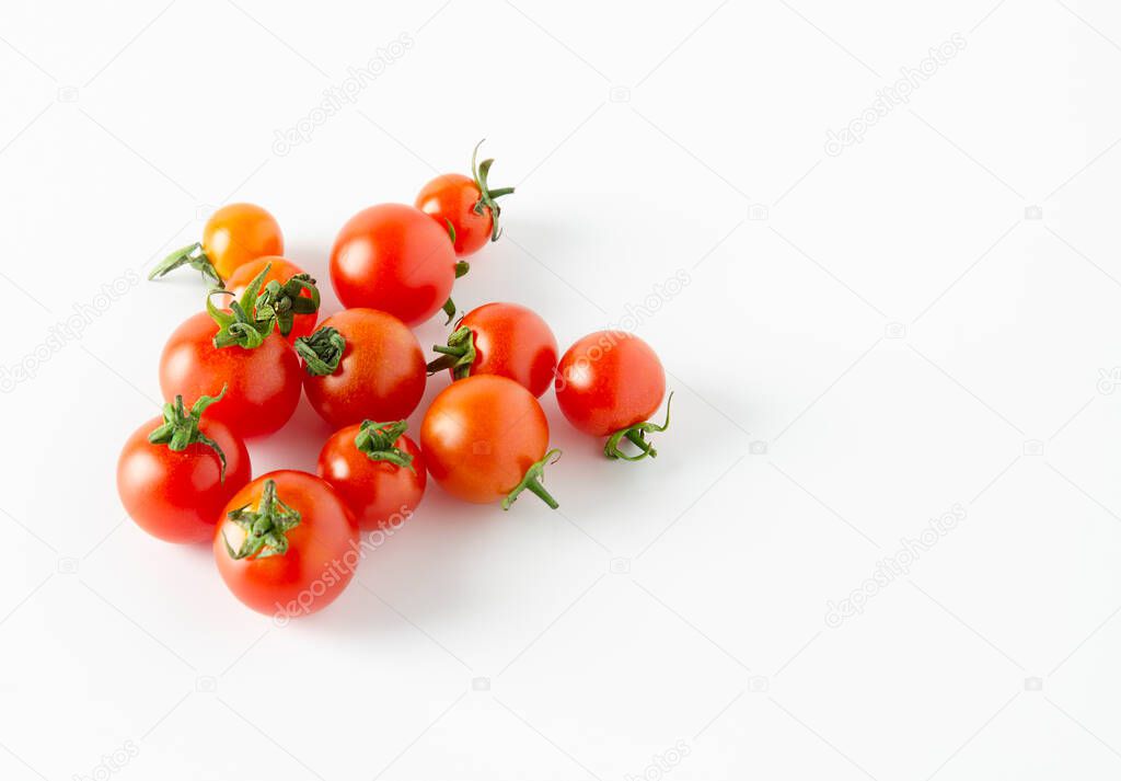Fresh cherry tmatoes on a white surface