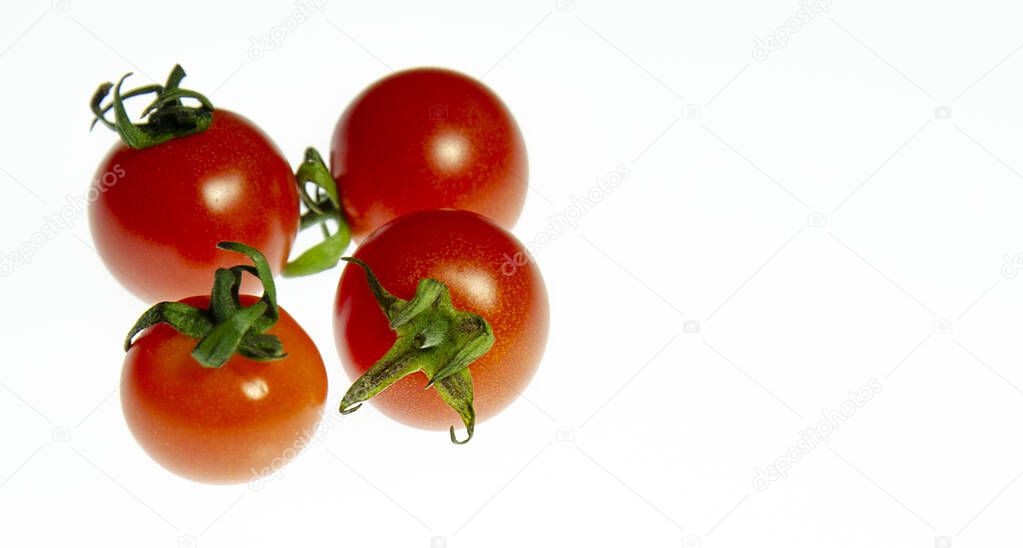 Fresh cherry tmatoes on a white surface. Mini tomato