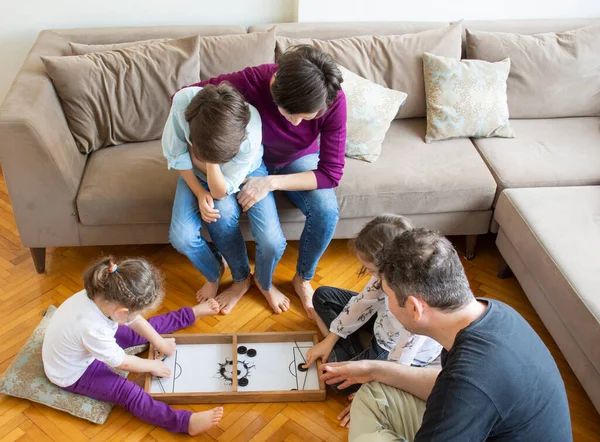 Whole Family playing game. sisters' match. Sitting on the floor in the middle of the living room playing games with the whole family