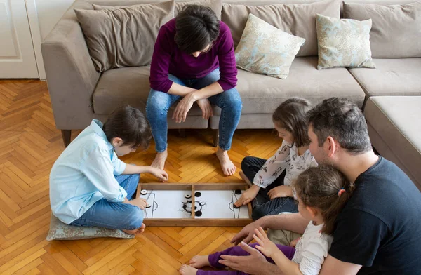 Whole Family playing game. Brother and sister girl playing. Sitting on the floor in the middle of the living room playing games with the whole family
