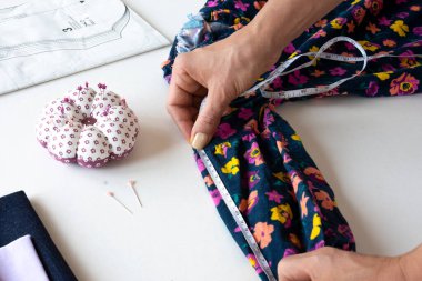 The final touches are made to the Dress sewn for doll. selective focus Dress