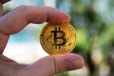 the man holds the coin between his fingers. selective Focus Coin