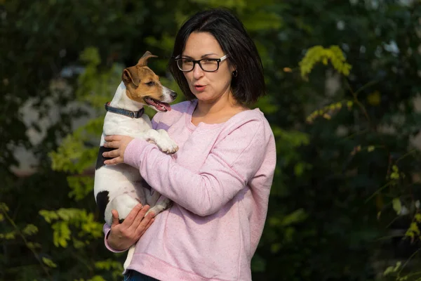 Young woman with a pet. Dog breed Jack Russell.