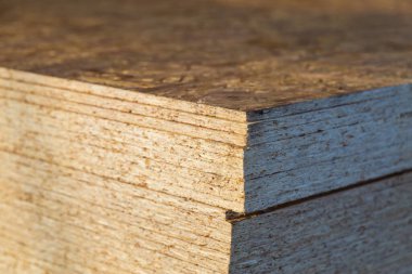 Çizgili tahta yığını toptan satış deposunda saklanıyor. Bulanık arkaplan ile seçici odak, alanın sığ derinliği.