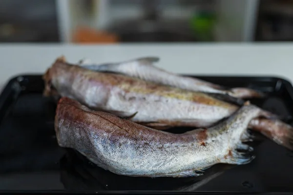 Raw fish hake. Abstract culinary background. Cooking healthy diet food. Selective focus.