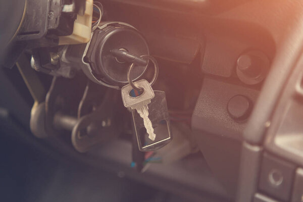 Keys in the ignition of an old car. Selective focus background