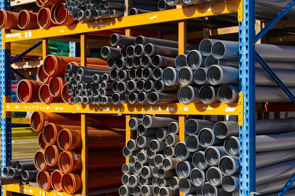 Sewage pipes of different diameters on the distribution center warehouse or DIY stores. Background
