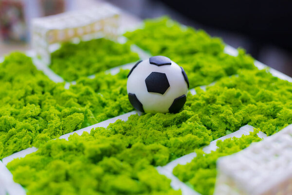 Cake with a classic soccer ball. Selective focus on blurred background.