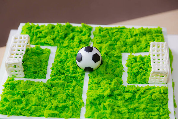 Cake with a classic soccer ball. Selective focus on blurred background.