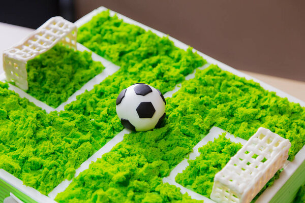 Cake with a classic soccer ball. Selective focus on blurred background.