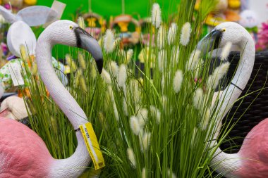 12 Nisan 2021 Beltsy, Moldova malları pazar rafında. Süpermarket vitrini. İllüstrasyon başyazısı. Dekoratif pembe flamingolar ve bahçe için yapay çiçekler.