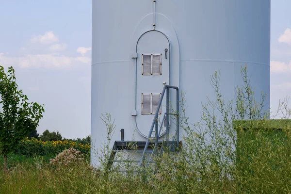 Windmills for electricity generation. Green energy concept. Background with copy space for text. Service entrance.