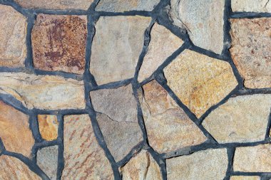 Vahşi bir taşın taklidi. Sert desenli yüzey. Tasarım için boş veya grafik kaynak arkaplanı.