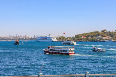 Scenic view of boats and ships on a bustling blue waterway under clear sky. August 12, 2025 Istanbul Turkey.