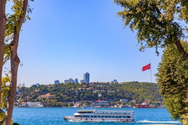 Scenic bosphorus view with ferry and turkish flag in istanbul. August 12, 2025 Istanbul Turkey.