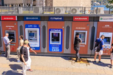 Outdoor atm machines with diverse users in urban setting. August 12, 2025 Istanbul Turkey.
