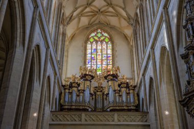 Ornate cathedral interior with historic stained glass and grand pipe organ.. March 22, 2025, Kutna Hora, Czech Republic.