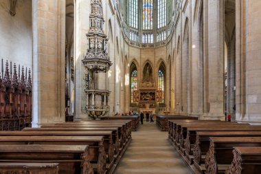 Interior of historic gothic cathedral with wooden pews and stained glass windows.. March 22, 2025, Kutna Hora, Czech Republic.