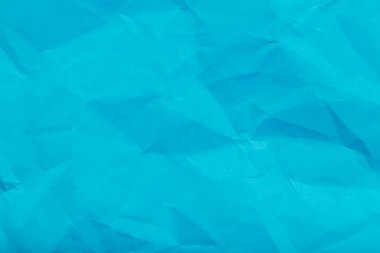 Textured blue paper background with geometric crumple patterns.