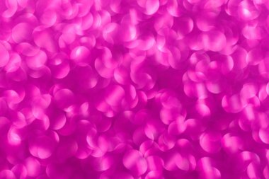 Pembe arka plan ve küçük pembe daireler. Çemberler bulanık ve örtüşüyor.