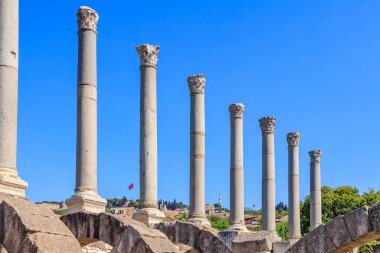 Tarihi harabelerde açık mavi gökyüzüne karşı antik Roma sütunları. İzmir, İzmir 'de antik İzmir kalıntıları.