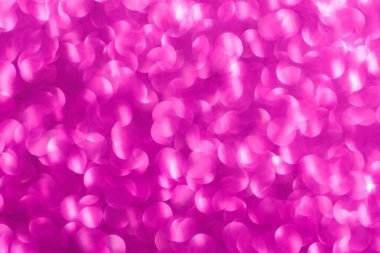 Pembe arka plan ve küçük pembe daireler. Çemberler bulanık ve örtüşüyor.